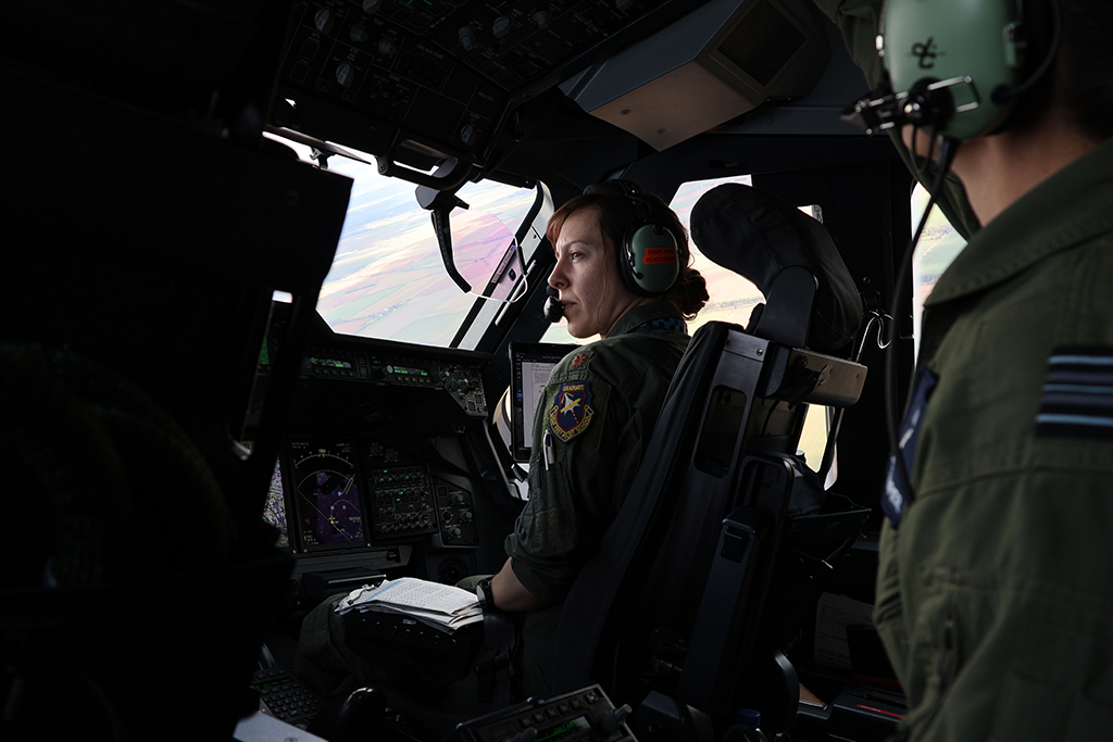 Photo: Image of the Atlas flight deck, taken from behind the Captain's seat, looking right past the Flight Test Engineer and the Co-Pilot, while in flight, looking forward and right through the windows.